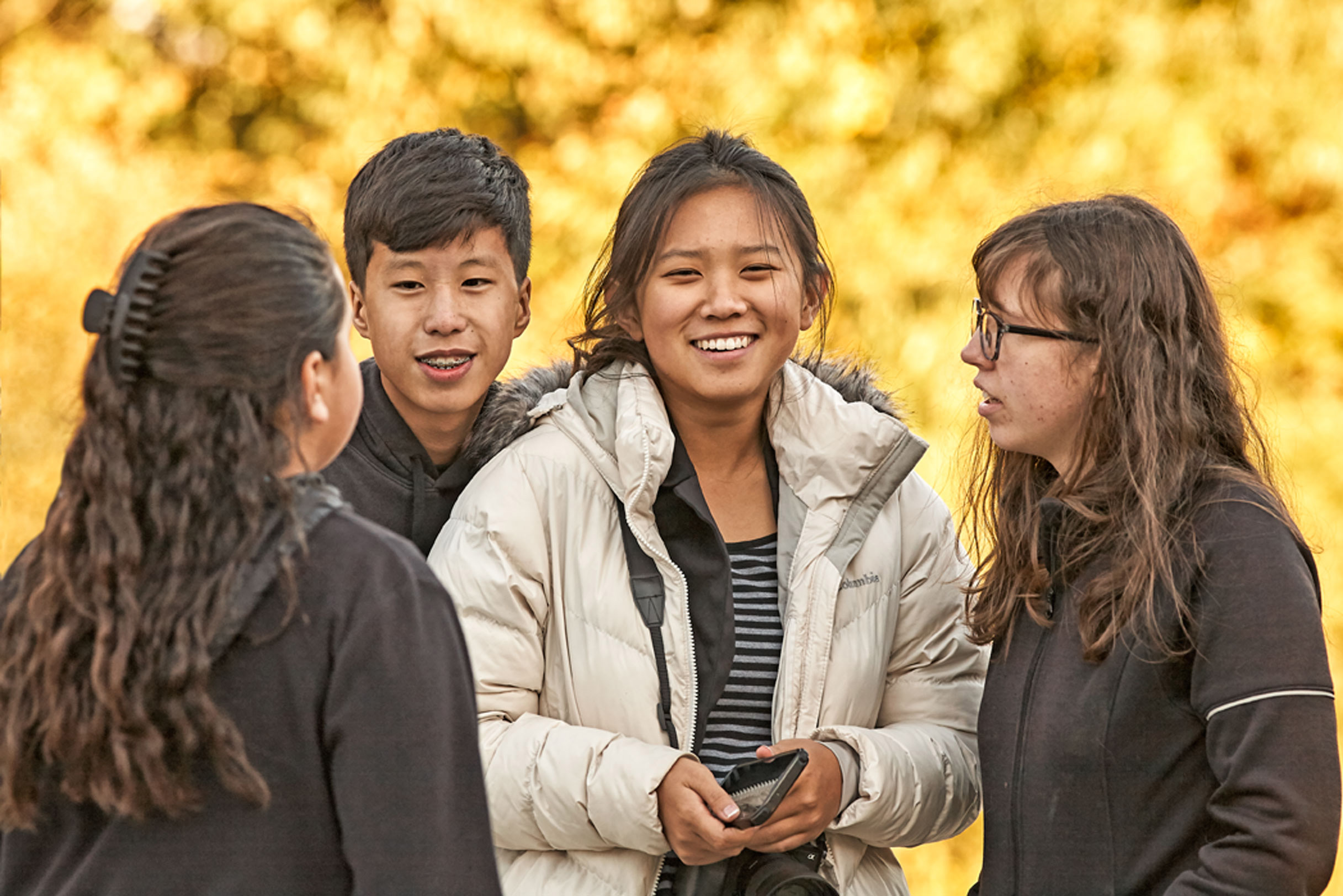Lifestyle Portrait With  Teens Outside Fall Foliage Using Bokeh To Enhance Scene At Warsaw CMI Revival 