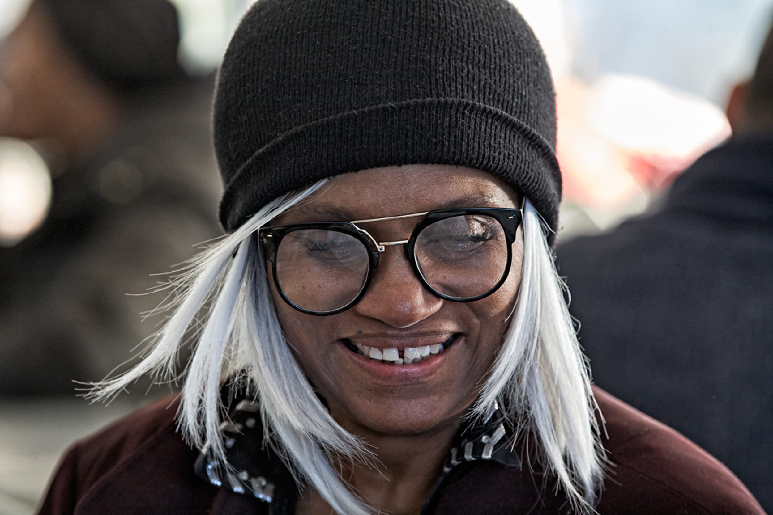  Lifestyle Portrait Photographer In North Central Ohio Woman With Glasses In Beanie Giggles Using Bokeh To Enhance Scene At Warsaw CMI Revival 