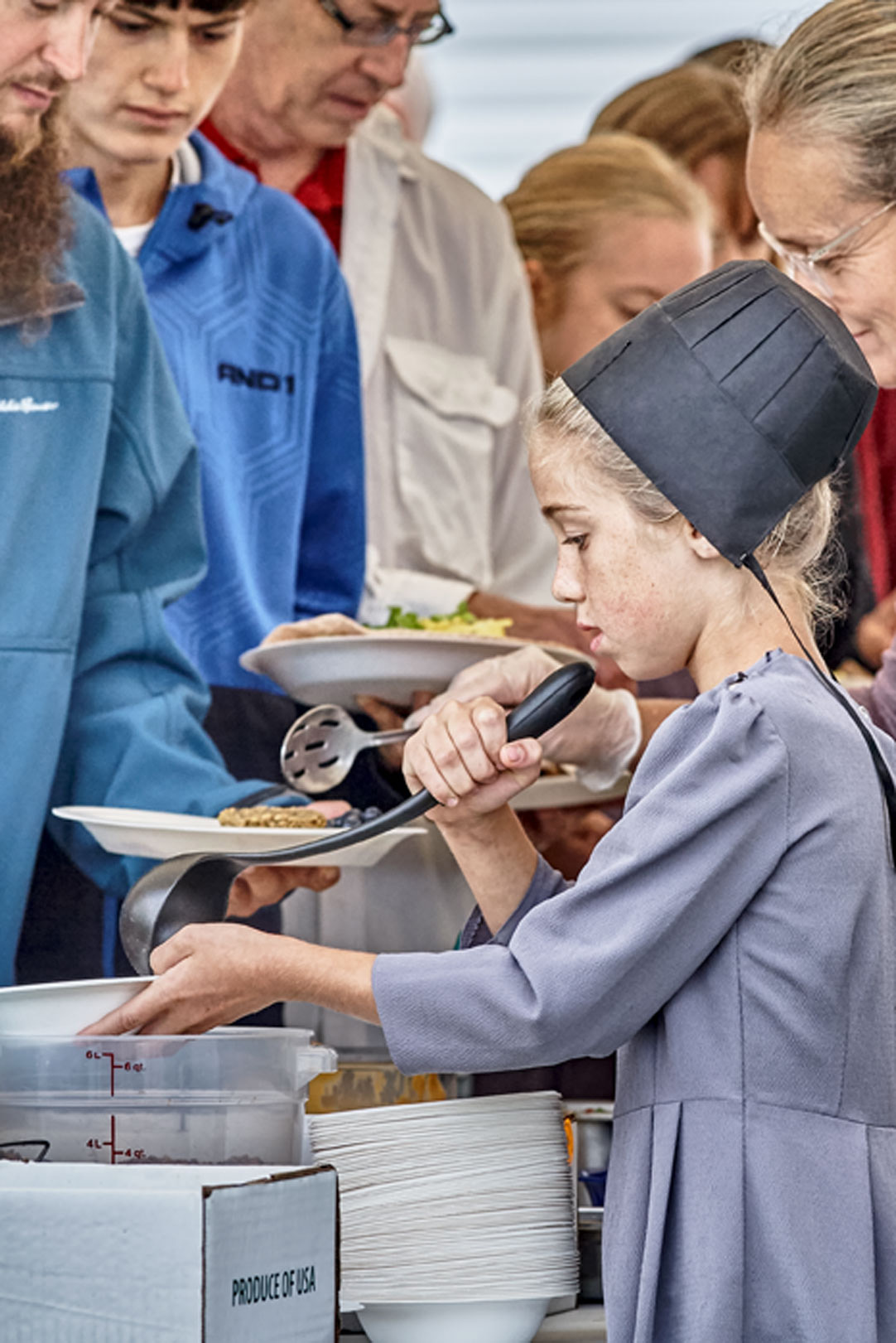 Lifestyle Portrait At West Salem Mission Campmeeting Focus On Amish Girl Wearing Gray Dress And Black Bonnet Serving Food 